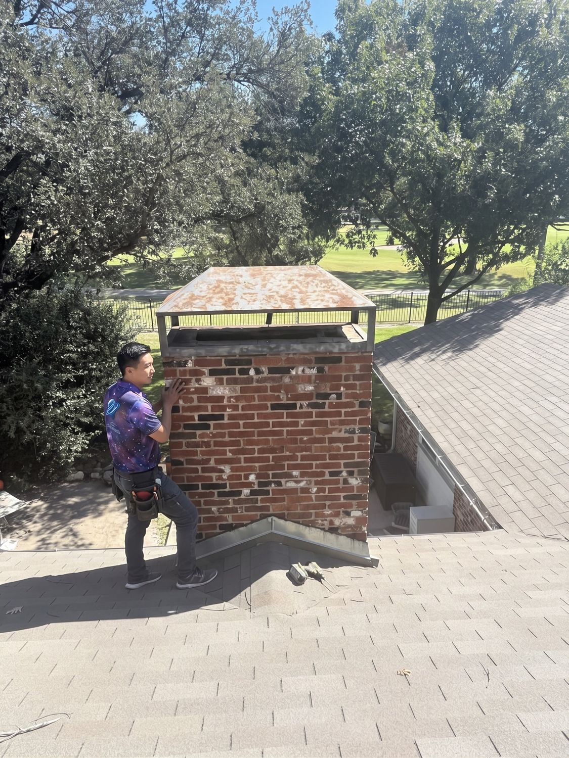 Space technician checking a brick chimney on a roof